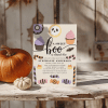 Halloween-Themed Baby Shower Invitation With Cupcakes, Candy, And A Skull.