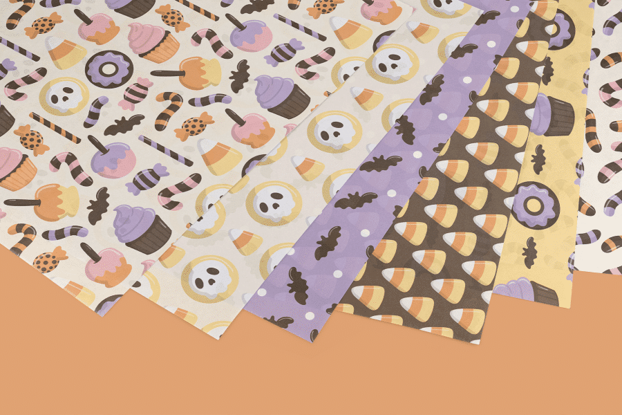 Five Sheets Of Halloween-Themed Wrapping Paper Featuring Various Candy And Spooky Designs.