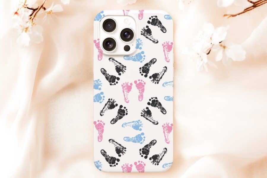 Phone Case With A Pattern Of Pink, Blue, And Black Baby Footprints.