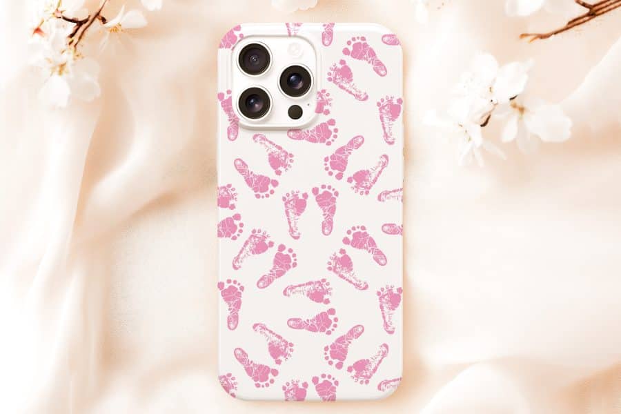 White Phone Case With A Pattern Of Pink Baby Footprints.