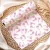 A Roll Of Wrapping Paper Featuring A Repeating Pattern Of Pink Baby Footprints On A White Background.