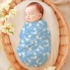 Sleeping Baby Swaddled In A Light Blue Baby Blanket With White Footprints.