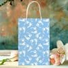 Light Blue Gift Bag With A Pattern Of White Baby Footprints.