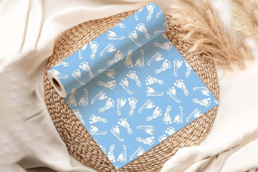Light Blue Wrapping Paper Roll With A Pattern Of White Baby Footprints.