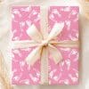 Pink Gift Box With A Beige Ribbon, Wrapped In Baby Footprints Design.