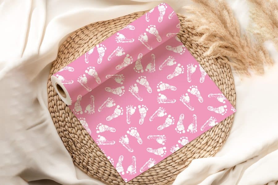 Pink Wrapping Paper With A Pattern Of White Baby Footprints.