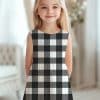 Girl Wearing A Black And White Buffalo Plaid Dress.