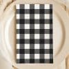 Black And White Checkered Napkin On A Beige Plate.