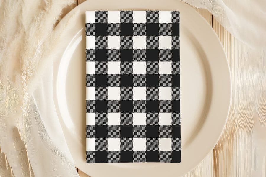 Black And White Checkered Napkin On A Beige Plate.