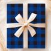 A Blue And Black Plaid Gift Box With A Beige Ribbon.