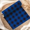 Roll Of Blue And Black Buffalo Plaid Fabric.