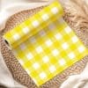 Roll Of Yellow And White Gingham Fabric On A Woven Mat.