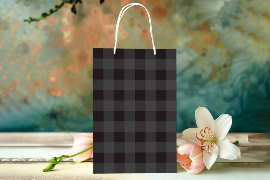 Black And Gray Checkered Gift Bag With White Handles.