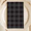 Black And Gray Plaid Napkin On A Beige Plate.