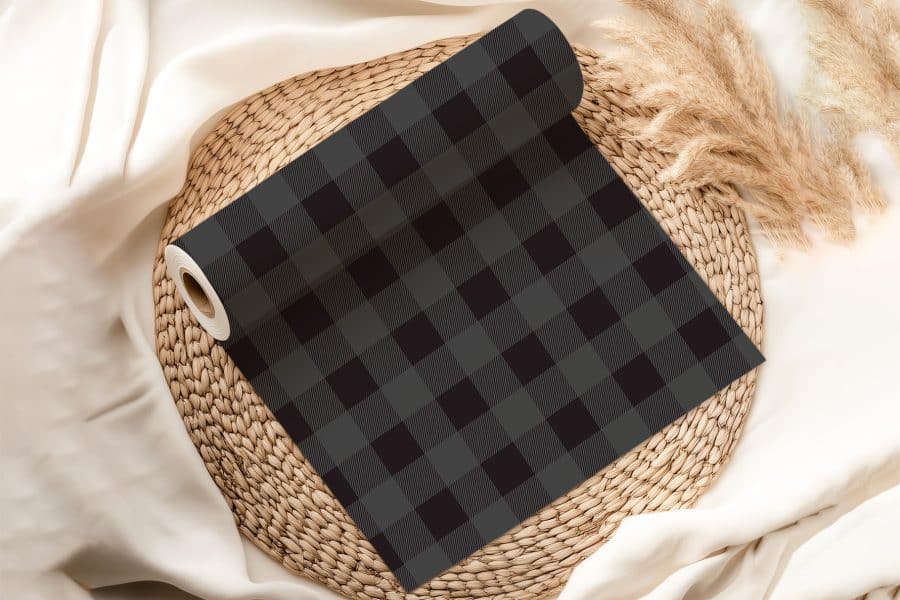 A Roll Of Dark Gray And Black Buffalo Plaid Fabric.