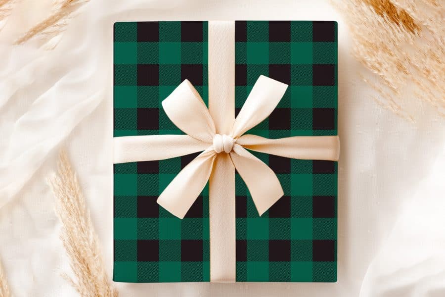 Green And Black Buffalo Plaid Gift Box With A Cream-Colored Ribbon.