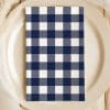 Navy Blue And White Checkered Napkin On A Beige Plate.