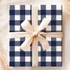 A Navy Blue And White Gingham Gift Box Tied With A Beige Ribbon.
