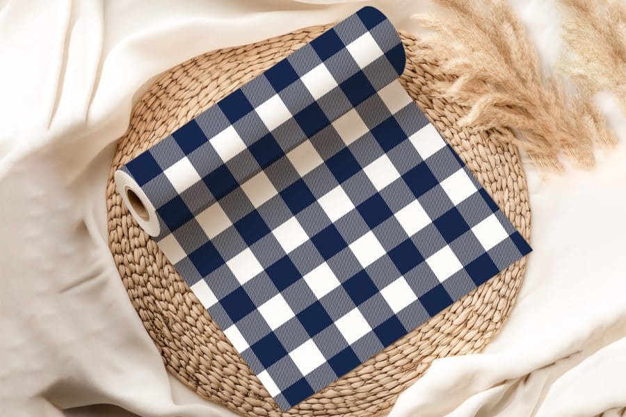 Roll Of Navy Blue And White Gingham Fabric On A Woven Mat.