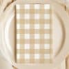 Beige And White Checkered Napkin On A Beige Plate.
