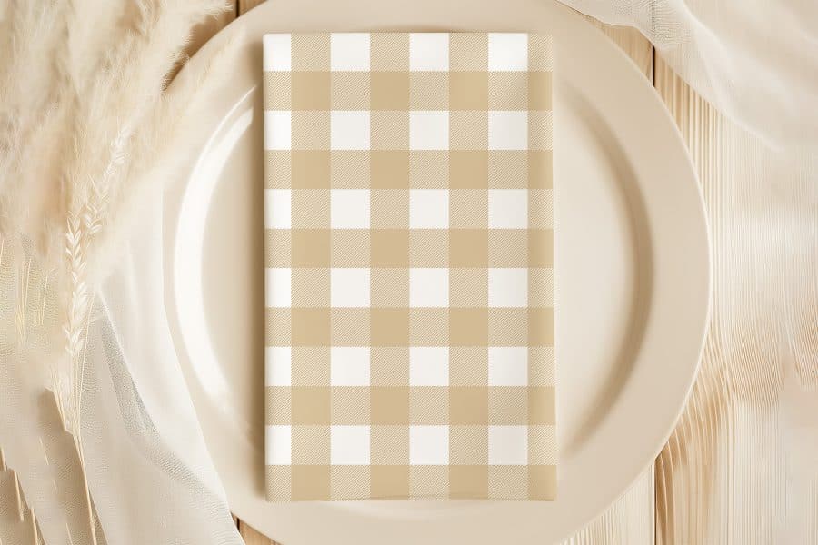 Beige And White Checkered Napkin On A Beige Plate.