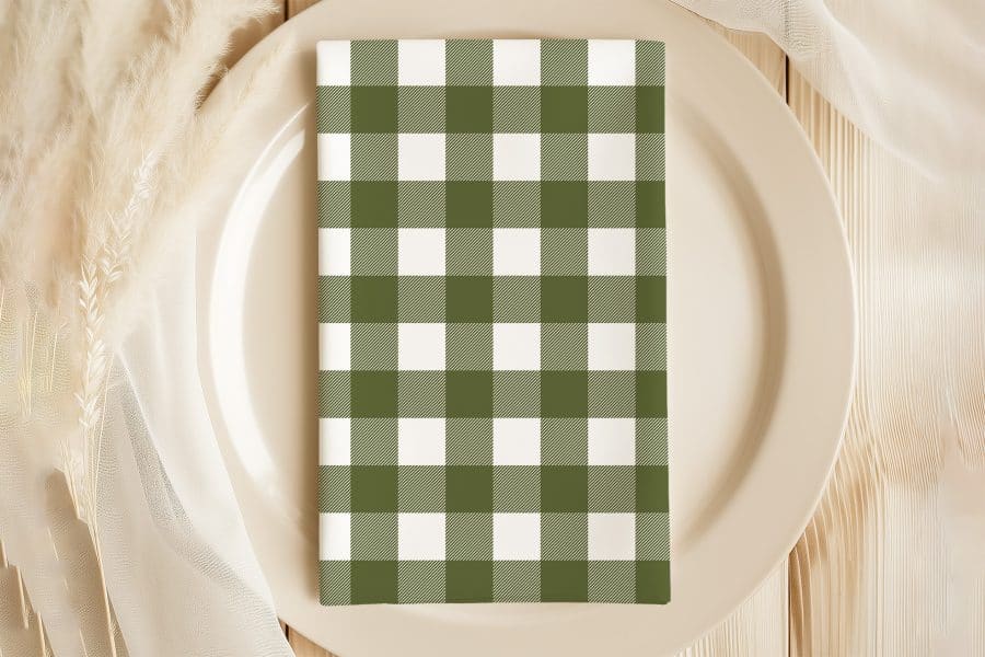 Olive Green And White Checkered Napkin On A Beige Plate.