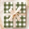 A Gift Wrapped In Olive Green And White Buffalo Plaid With A Beige Ribbon.