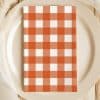 Orange And White Checkered Napkin On A Beige Plate.