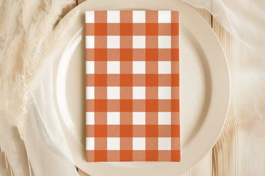 Orange And White Checkered Napkin On A Beige Plate.