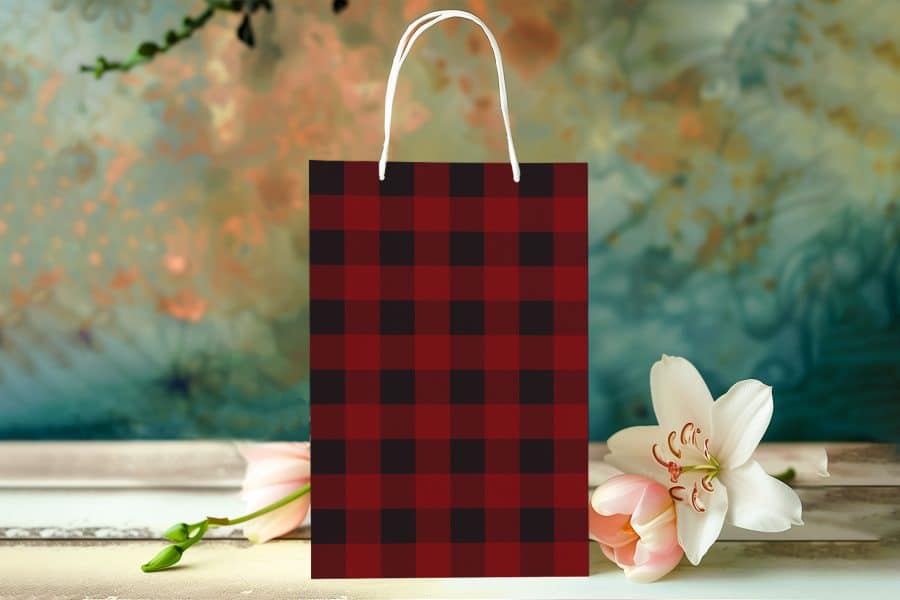 Red And Black Buffalo Plaid Gift Bag With White Handles.