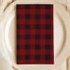 Red And Black Buffalo Plaid Napkin On A White Plate.