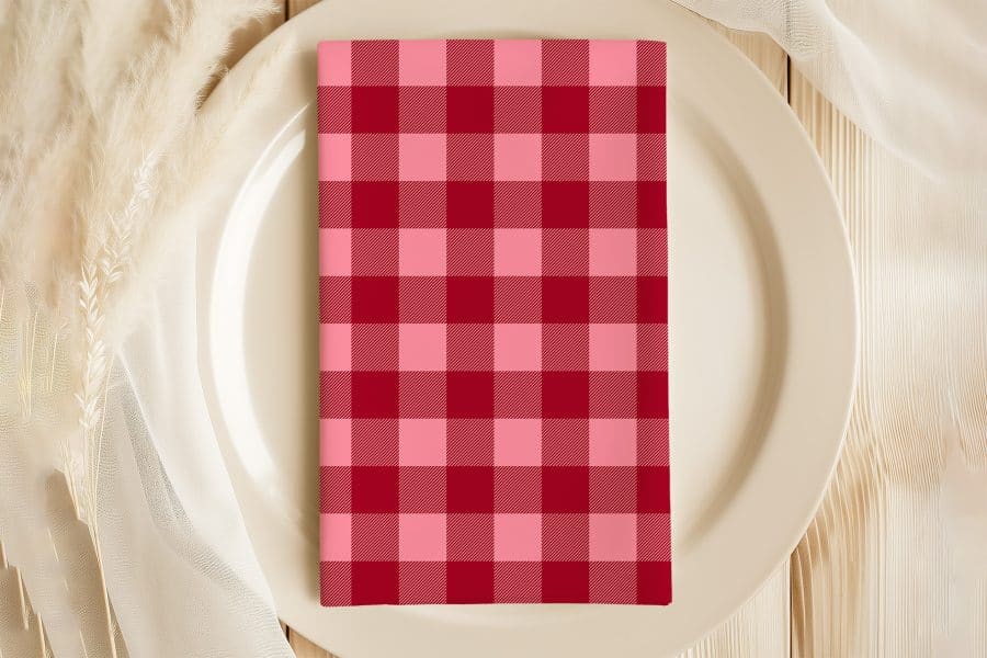 Red And Pink Checkered Napkin On A White Plate.