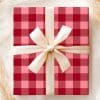 A Gift Box With A Red And Pink Plaid Pattern And A Cream-Colored Ribbon.