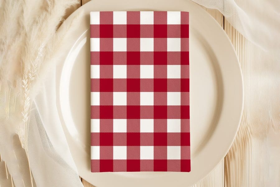 Red And White Checkered Napkin On A Beige Plate.