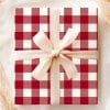 A Gift Wrapped In Red And White Gingham Paper With A Cream-Colored Ribbon.