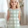 Girl Wearing A Sage Green And White Gingham Dress.