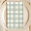 Sage Green And White Checkered Napkin On A Beige Plate.