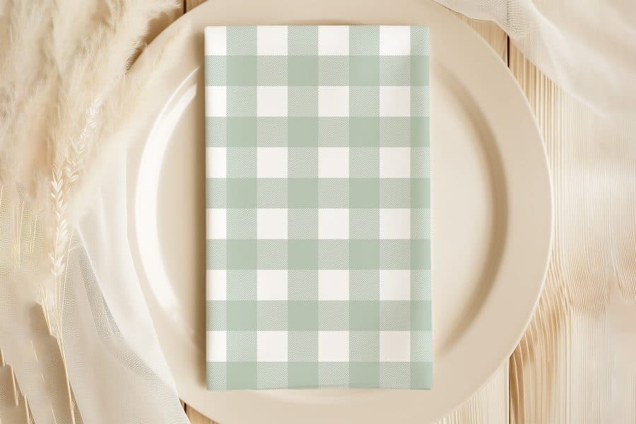 Sage Green And White Checkered Napkin On A Beige Plate.