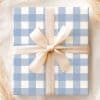 A Gift Box With A Light Blue And White Gingham Pattern And A Beige Ribbon.