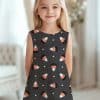 Girl Wearing A Dark Gray Sleeveless Dress With A Candy Corn Pattern.