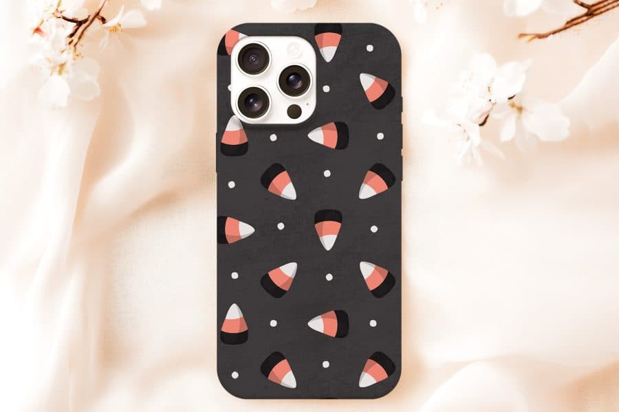 Black Iphone Case With A Pattern Of Candy Corn And White Dots.