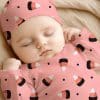 Sleeping Baby Wearing A Pink Candy Corn Onesie And Matching Hat.