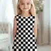 Young Girl Wearing A Black And White Checkered Dress.