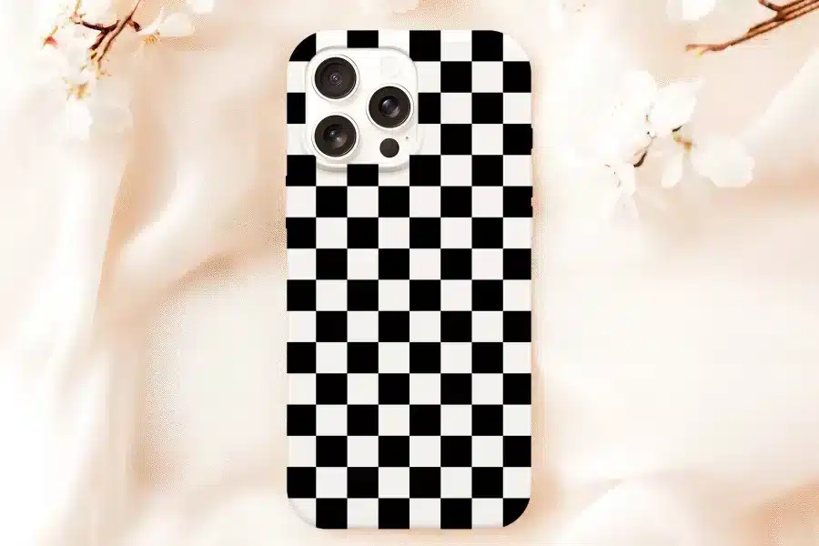 White Phone Case With A Black And White Checkered Pattern.