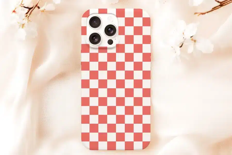Phone Case With Coral And White Checkered Pattern.