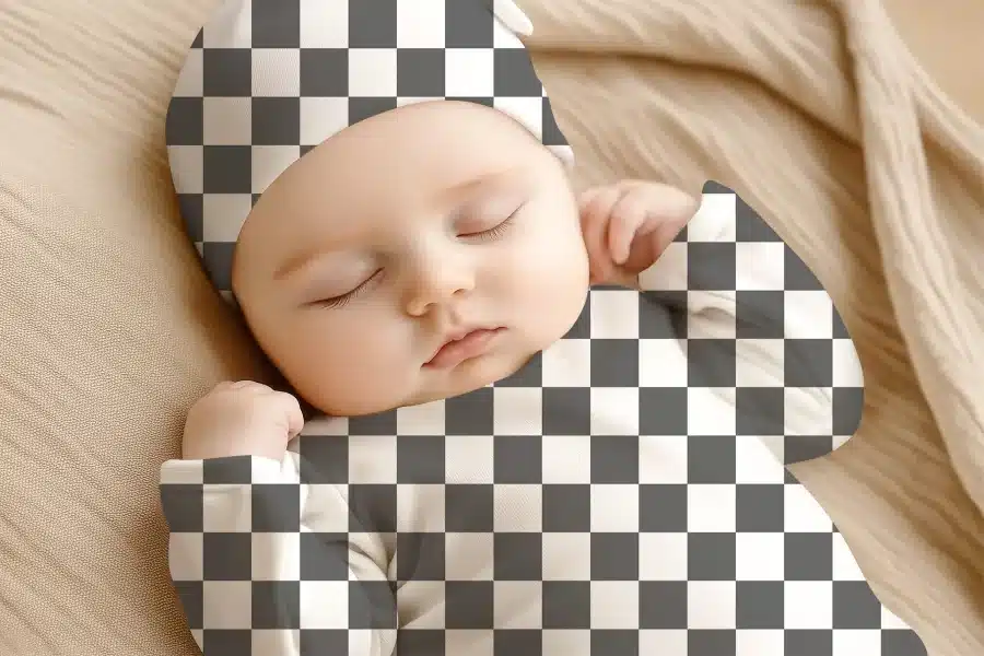 Sleeping Baby Wearing A Checkered Onesie And Hat.