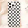 White Phone Case With A Black And White Checkered Pattern.