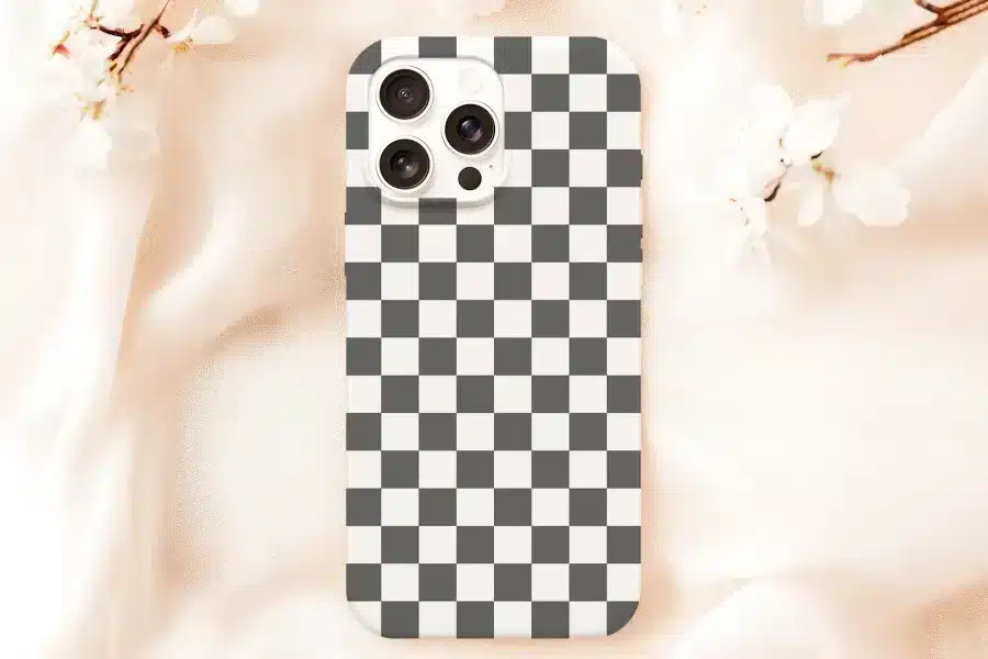 White Phone Case With A Black And White Checkered Pattern.