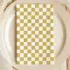 Beige Plate With A Mustard Yellow And White Checkered Napkin.
