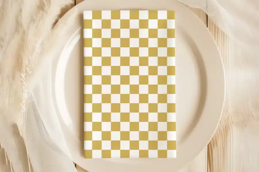 Beige Plate With A Mustard Yellow And White Checkered Napkin.